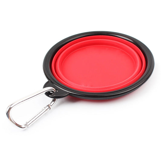 Flat, collapsed red silicone pet bowl with black rim and silver clip