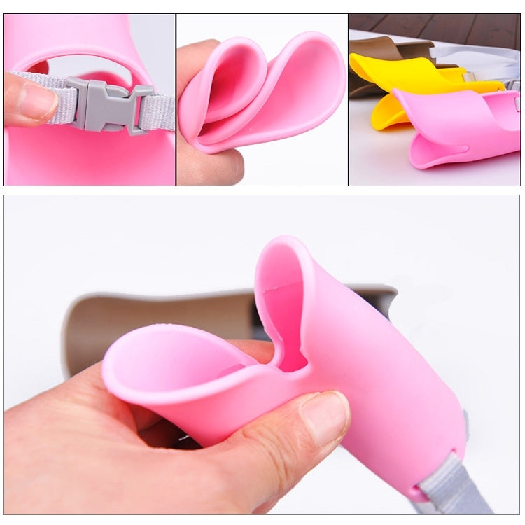 Pink silicone duck-mouth muzzle with gray strap, shown close-up in hand