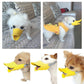 Yellow silicone duck-mouth muzzle with gray straps worn by small dogs