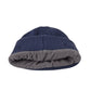 Navy blue beanie with folded cuff showing gray underside and brown control patch