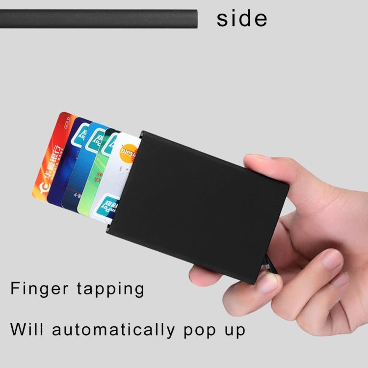 Black card holder with cards partially extended, hand holding the case