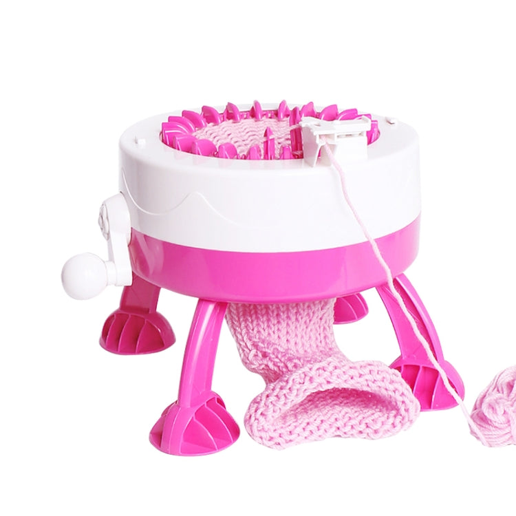 Pink and white knitting machine toy showing textured knit area and yarn