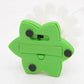 Green underside of flower cat toy base with screw holes and molded panel detail