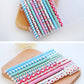 Colorful 0.5mm gel pen set with floral polka-dot and striped barrels on wooden tray