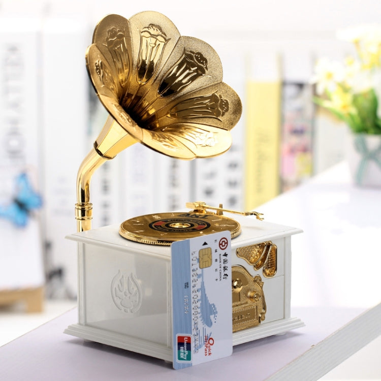 Gold-tone phonograph-style music box with gramophone horn on white base