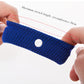 Blue knit anti-nausea wristband stretched on fingers, with round white button.