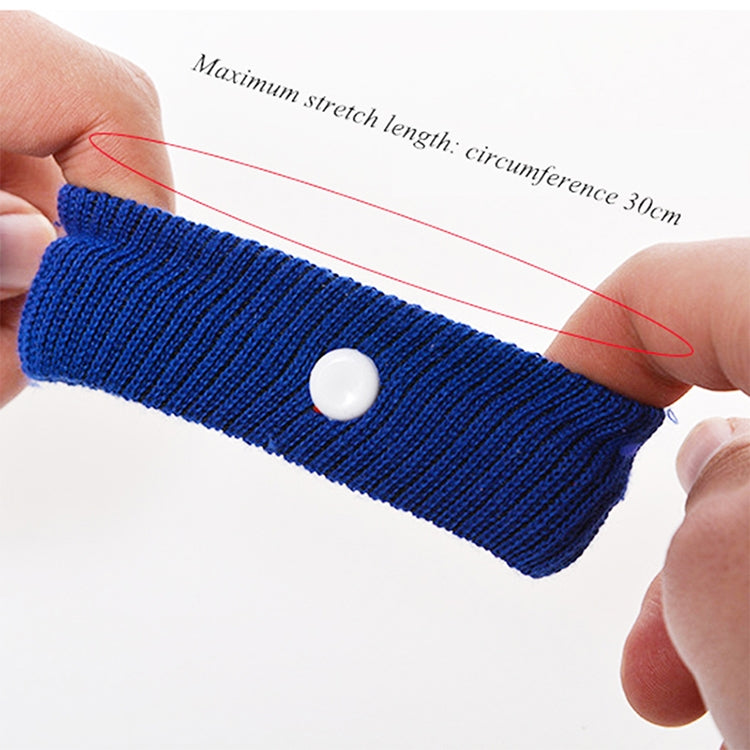 Blue knit anti-nausea wristband stretched on fingers, with round white button.