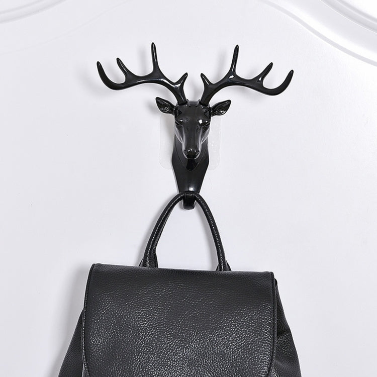 Dark deer head wall hook with four antlers, mounted metal loop for hanging