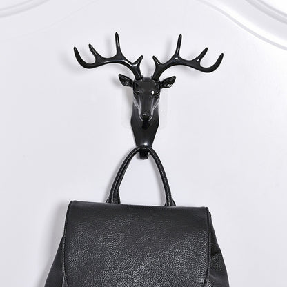Dark deer head wall hook with four antlers, mounted metal loop for hanging