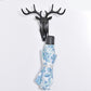 Dark deer head wall hook holding a gray-capped hanging cloth with blue pattern