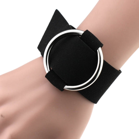Black velvet round metal wrist bracelet with suede-like strap and circular ring.