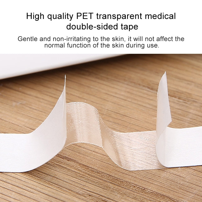 Transparent curved double-sided adhesive tape pads on a wooden surface