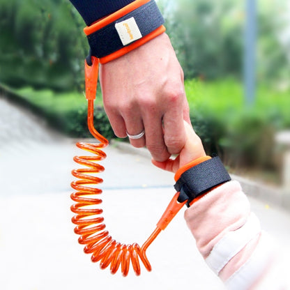 Orange anti-lost kids wrist harness with coiled safety leash rope, spring extension.