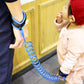 Blue coiled leash spring with padded wrist cuff and elastic connection loop.