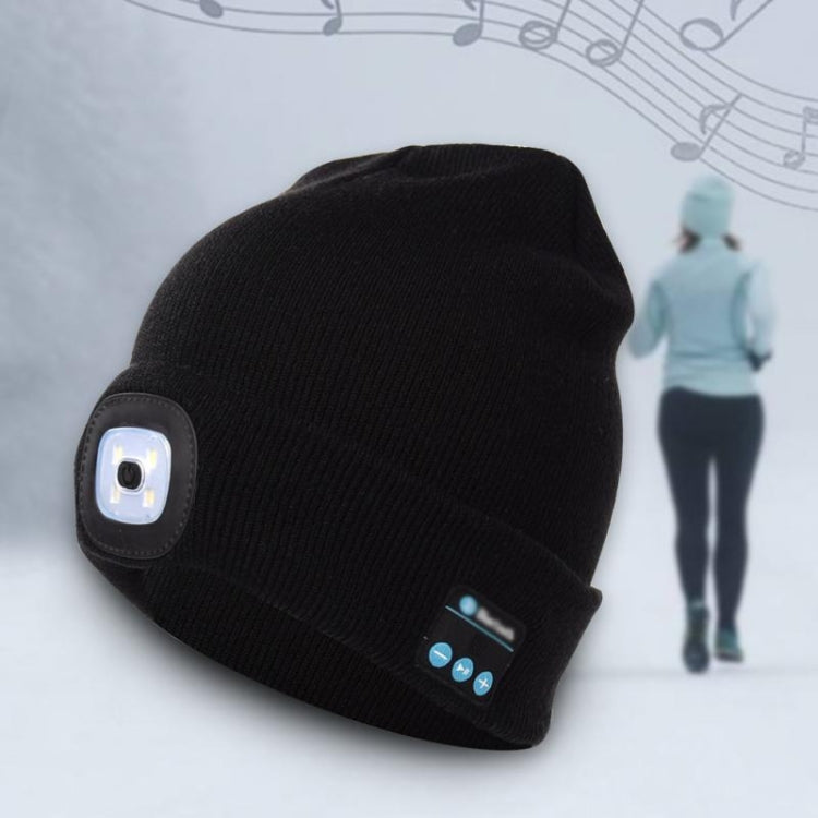 Black knit beanie with LED module and blue Bluetooth control panel at cuff