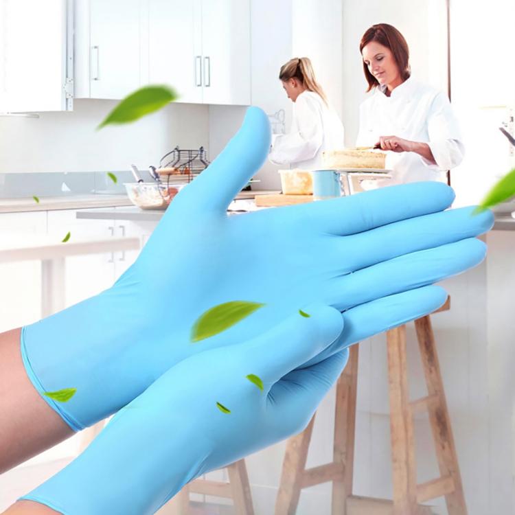 Blue disposable nitrile gloves worn in a kitchen, hands at work