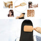 Wooden massage hair brush held to smooth dark hair