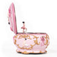 Pink ballerina music box with gold filigree trim and open rotating compartment