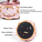 Underside of pink music box showing battery compartment, clockwork, and switch
