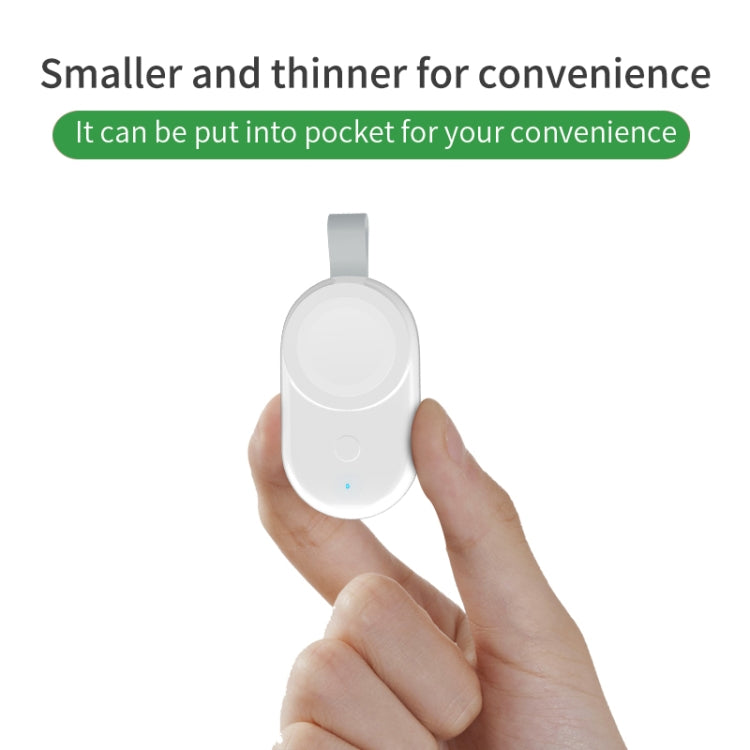 Small white portable wireless charger for Apple Watch held in a hand with indicator light