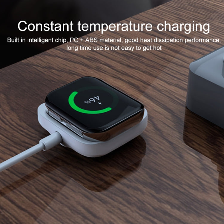 White magnetic charging base with watch docked on the round contact pad