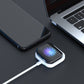 Compact white magnetic watch charger base with USB cable and watch positioned on pad