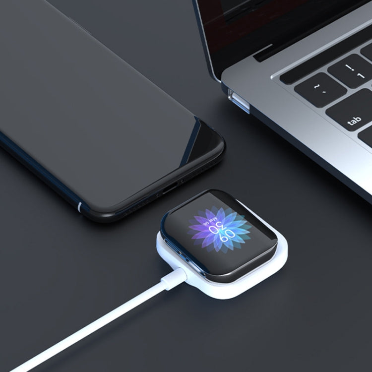Compact white magnetic watch charger base with USB cable and watch positioned on pad