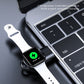 Black magnetic wireless watch charger connected to laptop USB port