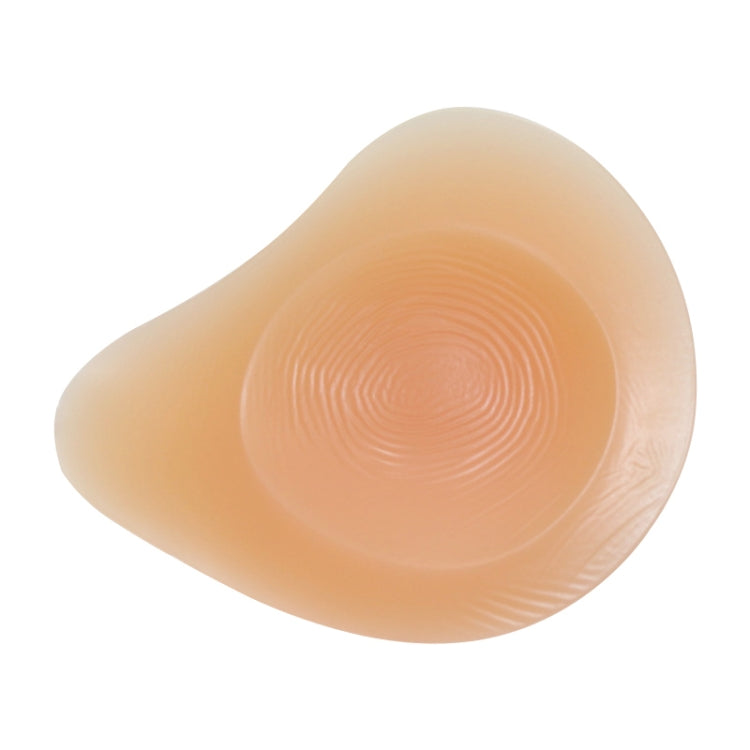Left silicone breast pad, concave back with spiral texture, beige