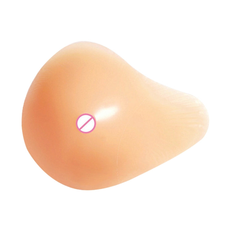 Left silicone breast pad with nipple cover, smooth spiral shape in peach tone.