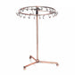 Rose gold rotating jewelry rack with oval top bar and multiple hanging hooks