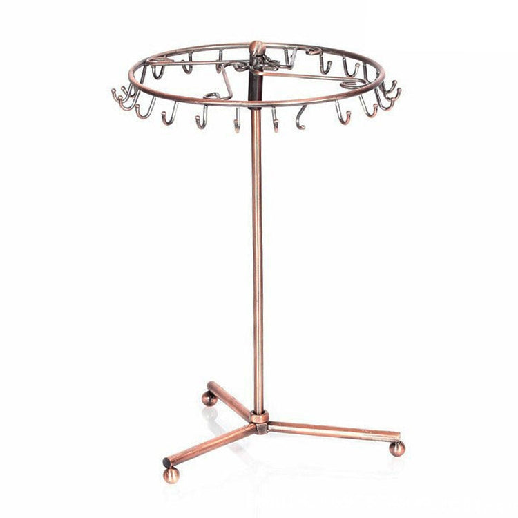 Rose gold rotating jewelry rack with oval top bar and multiple hanging hooks