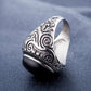 Men’s oval black-stone ring with engraved silver swirl band, open-side view