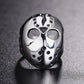 Front view skull mask ring with two eye cutouts, central emblem, stud border