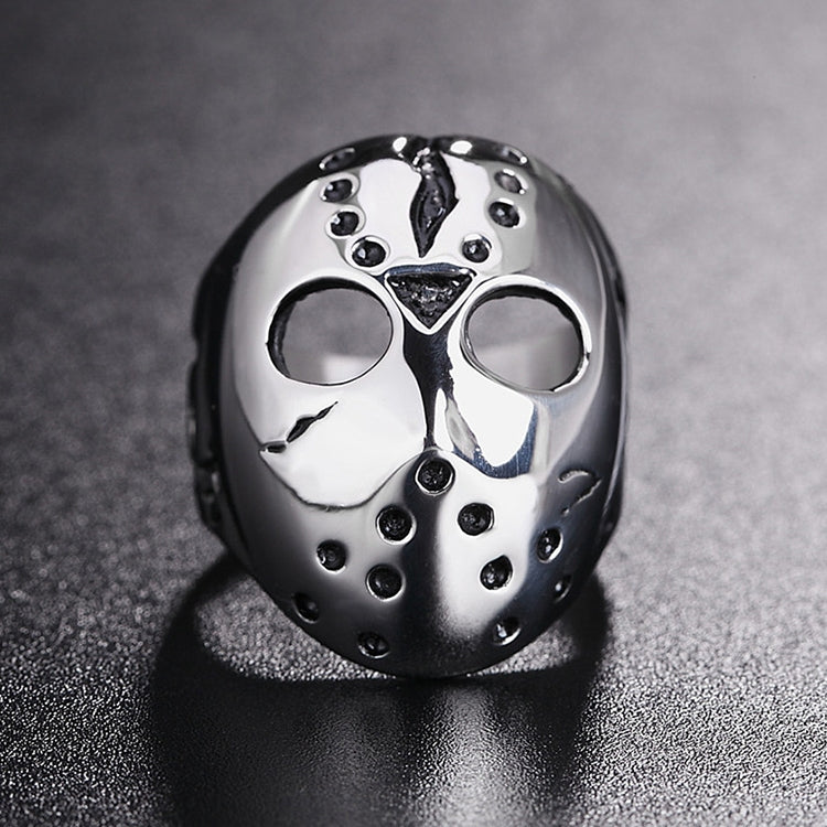 Front view skull mask ring with two eye cutouts, central emblem, stud border