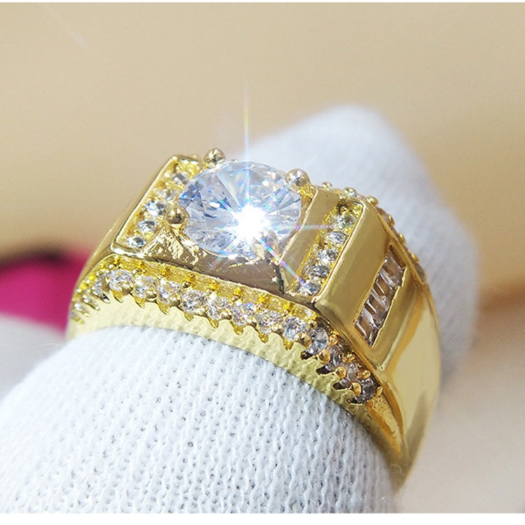 Gold-plated men’s diamond ring with bright round center stone under fingertip