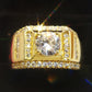 Gold-plated men’s diamond ring with square frame, center round stone, and sparkly halo