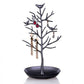 Black tree-shaped jewelry display with bird accents and round earring tray