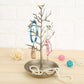 Gold-toned tree-shaped jewelry organizer with bird charms and pearl necklace display