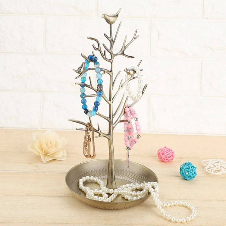 Gold-toned tree-shaped jewelry organizer with bird charms and pearl necklace display