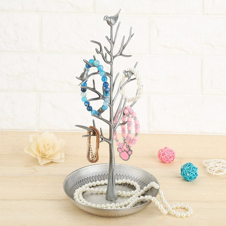Silver-toned tree jewelry display with bird charms and pearl, blue, and pink beads