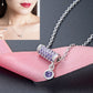 Silver chain necklace with rectangular purple crystal bar pendant and round purple drop charm