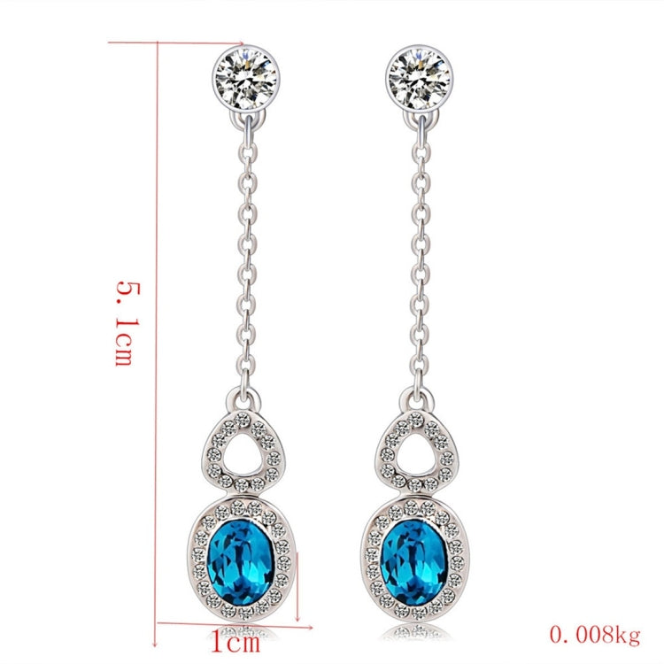 Silver-plated dangling earrings with blue crystal teardrop centers and clear stone details