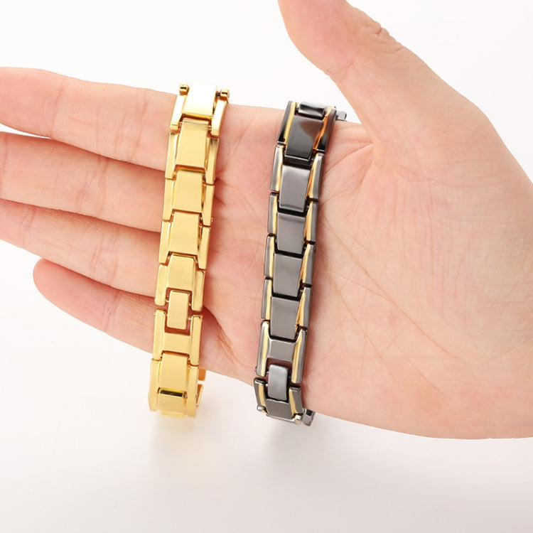 Men's titanium steel bracelet pair: gold and silver-tone link bands on hand