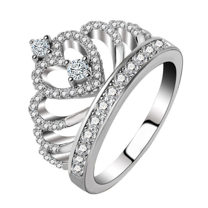 Crown-shaped zircon ring with round stones and halo setting, platinum-plated finish