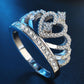 Crown-shaped zircon ring, side view with raised halo and sparkling stones