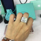 Silver-tone rectangular rhinestone ring on finger with square clear center stone