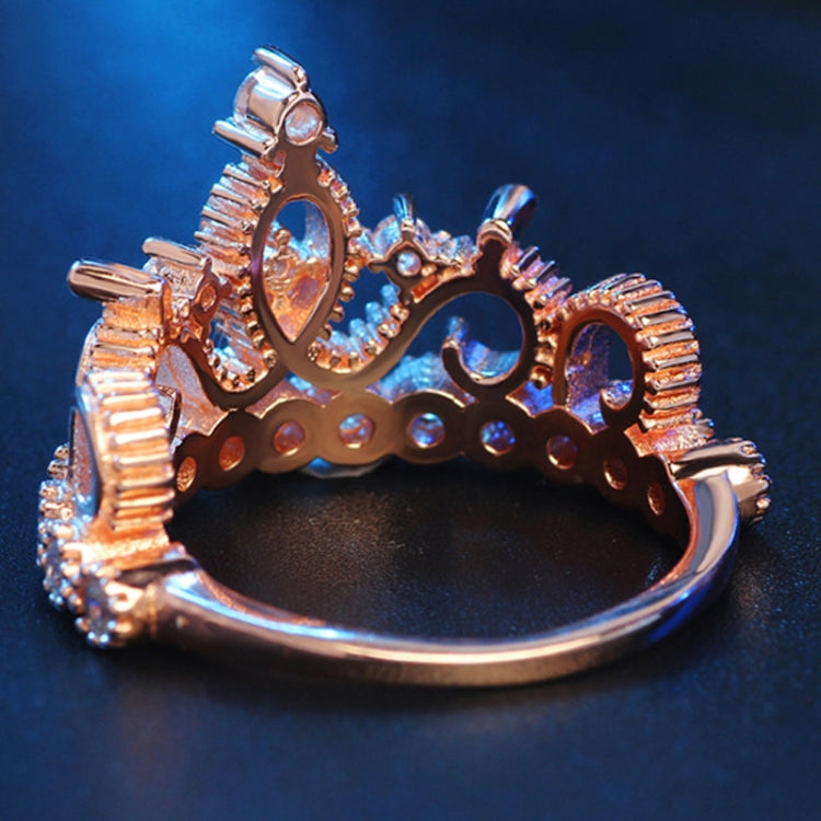 Rose gold crown ring underside view with zircon-studded frame and band