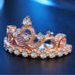 Rose gold crown tiara zircon ring with central round stone and decorative heart details