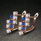 Rose gold-tone crystal cluster stud earrings with blue and clear stones